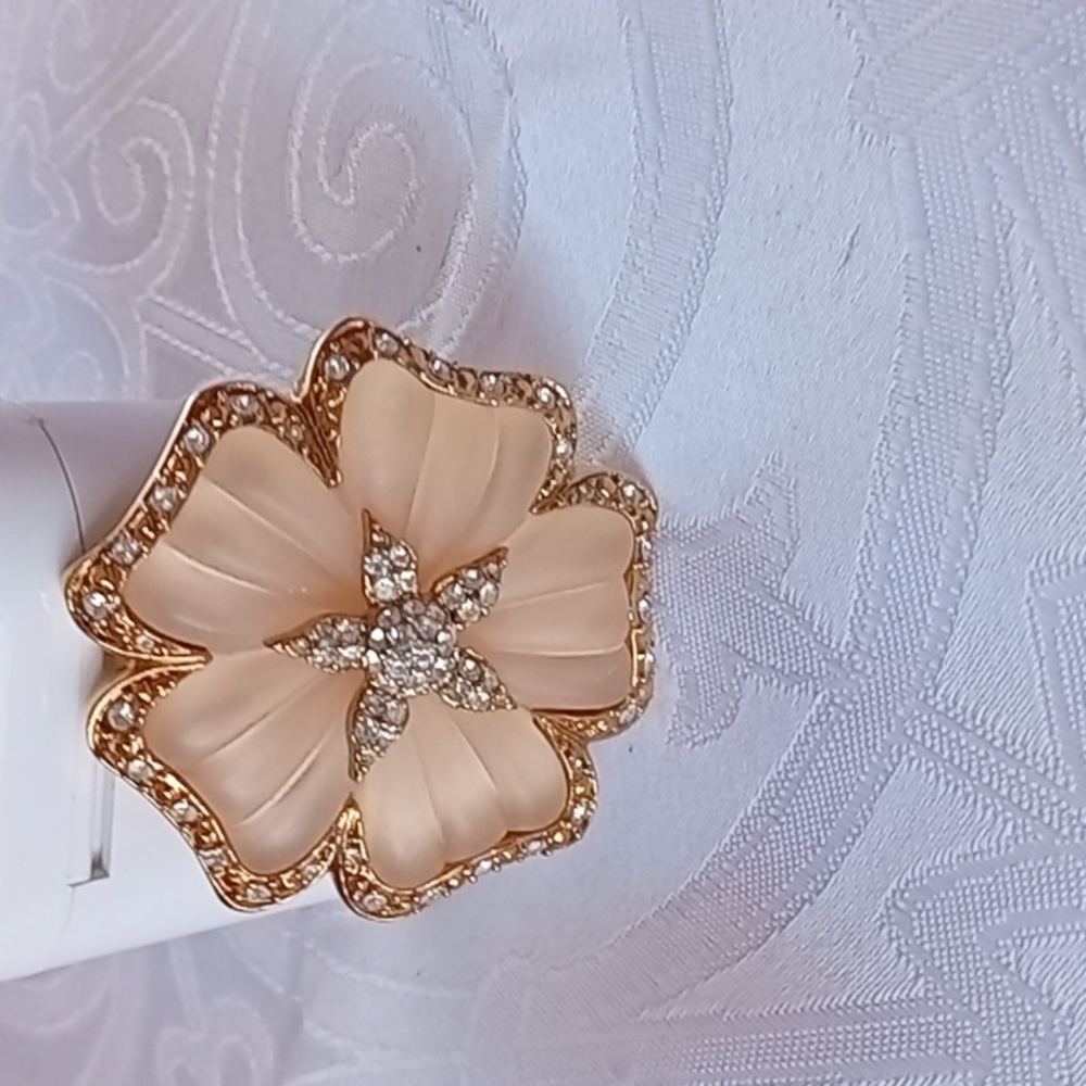 Brooch set with carved frosted pink glass set in a gold flower frame